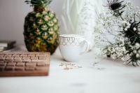 Kaboompics - Pineapple, Coffee and Wooden Keyboard with White Flowers