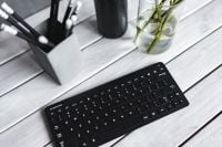 Kaboompics - Angled Black Samsung Keyboard with Pencils and Glass Vase on White Desk