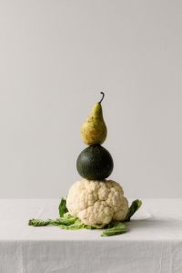 Kaboompics - Pear, Dark Green Vegetable and Cauliflower Stacked in Surreal Food Still Life