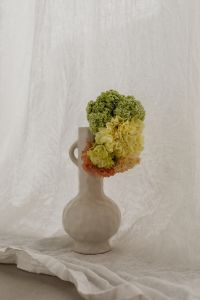 Kaboompics - Round White Vase with Green and Yellow Flowers