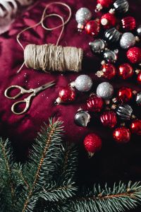 Kaboompics - Burgundy Christmas Ornaments with Spruce Branches and Soft Light