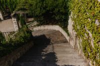 Kaboompics - Old Stone Garden Steps Leading Down Between Green Walls