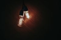 Kaboompics - Two Vintage Edison Pendant Bulbs on a Dark Wooden Background, Industrial Lighting