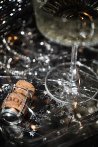 Kaboompics - Champagne Coupe, Cork and Star Confetti on a Party Tray
