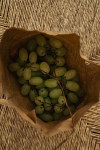 Kaboompics - Green Grapes in Paper Bag on Woven Chair