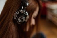 Kaboompics - Beautiful young woman in headphones listening to music