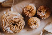 Kaboompics - Powdered Polish Pączki in a Paper-Lined Box, Overhead Food Photo