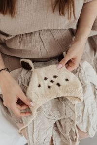 Kaboompics - Pregnant Woman Holding a Knitted Baby Sweater