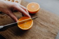 Kaboompics - Cutting the oranges with knife