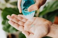 Kaboompics - Hands Dispensing Blue Hand Sanitizer Gel Outdoors