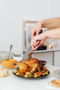 Kaboompics - Close-Up of Knife Carving Roast Turkey with Autumn Vegetables
