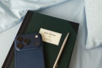 Kaboompics - Smartphone Pen and Dark Green Planner on Blue Bed