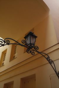 Kaboompics - Ornate Wrought Iron Street Lantern Against an Ochre Facade