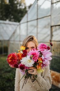 Kaboompics - Woman Hidden Behind A Flower Filled Dahlia Bouquet