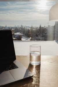 Kaboompics - Laptop Desk by Window Overlooking a Cloudy City