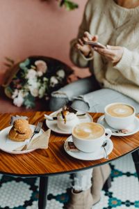 Kaboompics - Woman Checking Her Phone over Coffee and Dessert in a Cafe