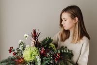 Kaboompics - Woman With Colorful Christmas Greenery Arrangement