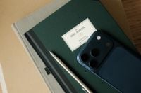 Kaboompics - Smartphone on Dark Green Journal and Notebook Stack