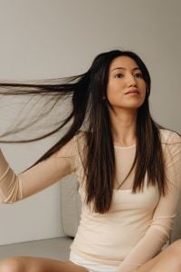 Kaboompics - Woman Sweeping Her Long Dark Hair to the Side in Neutral Loungewear