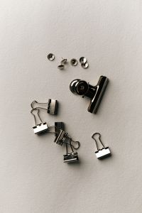Kaboompics - Black Binder Clips and Push Pins on White Background
