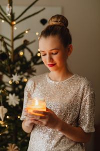 Kaboompics - Woman Holding Candle beside Christmas Tree
