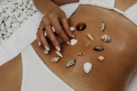 Kaboompics - Hand Arranging Seashells on Sunlit Skin, Beach Beauty Concept