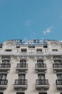 Kaboompics - Vertical White Madrid Hotel Facade with Ornate Balconies and Rooftop Sign