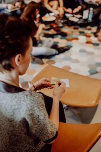 Kaboompics - Blurred View of People Folding Paper at an Origami Workshop