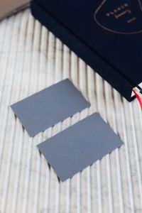 Kaboompics - Blue Business Cards and Navy Planner on White Ribbed Marble