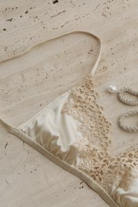 Kaboompics - Beige Satin Bra with Silver Earrings and Pearls