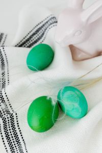 Kaboompics - Green and Turquoise Easter Eggs on Textured White Linen