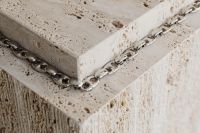 Kaboompics - Silver Chain Draped Around a Travertine Table Edge