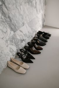 Kaboompics - Assorted Leather Shoes Along Marble Wall