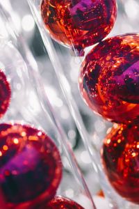 Red Christmas Baubles in Clear Tubes with Festive Reflections