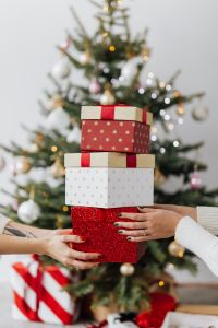 Kaboompics - Stacked Christmas Presents in Front of a Decorated Tree
