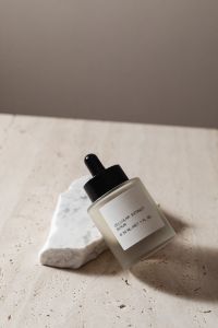 Kaboompics - Angled Serum Bottle on Travertine Stone for Minimal Skincare Product Mockup
