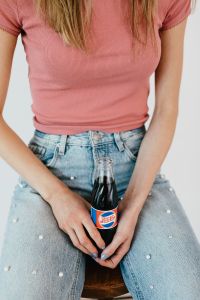 Young woman with Pepsi Cola bottle