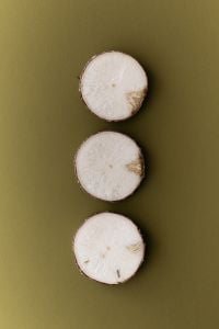 Kaboompics - Sliced Root Vegetable on Olive Green Background
