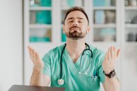 Kaboompics - Doctor Raising Hands in Medical Office