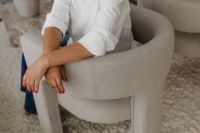 Kaboompics - Woman Relaxing in a Neutral Armchair
