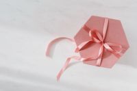 Kaboompics - Light pink velvety box with satin ribbon on white marble