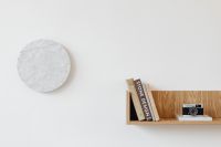 Kaboompics - Wooden Wall Shelf with Books and Vintage Camera Against White Wall