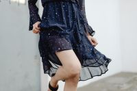 Kaboompics - Cropped Woman Walking in Navy Polka Dot Dress with Sheer Ruffles