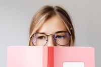 Kaboompics - Close Up of Student Wearing Glasses and Holding Notebook