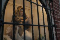 Kaboompics - Madonna and Child Statue Behind a Wrought Iron Shop Window