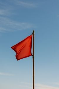 Kaboompics - Red Warning Flag Against Blue Sky