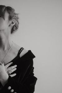 Kaboompics - Black and White Portrait of Woman Touching Pendant Necklace