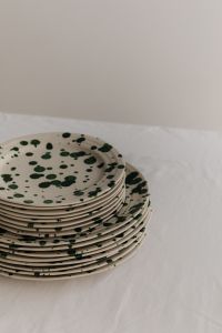 Kaboompics - Green Splatter Plate Stack with Tall Neutral Background