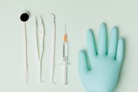 Kaboompics - Dental Tools, Syringe and Nitrile Glove on Mint Green