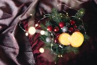 Kaboompics - Burgundy Christmas Decorations with Evergreen Sprigs and Golden Bokeh